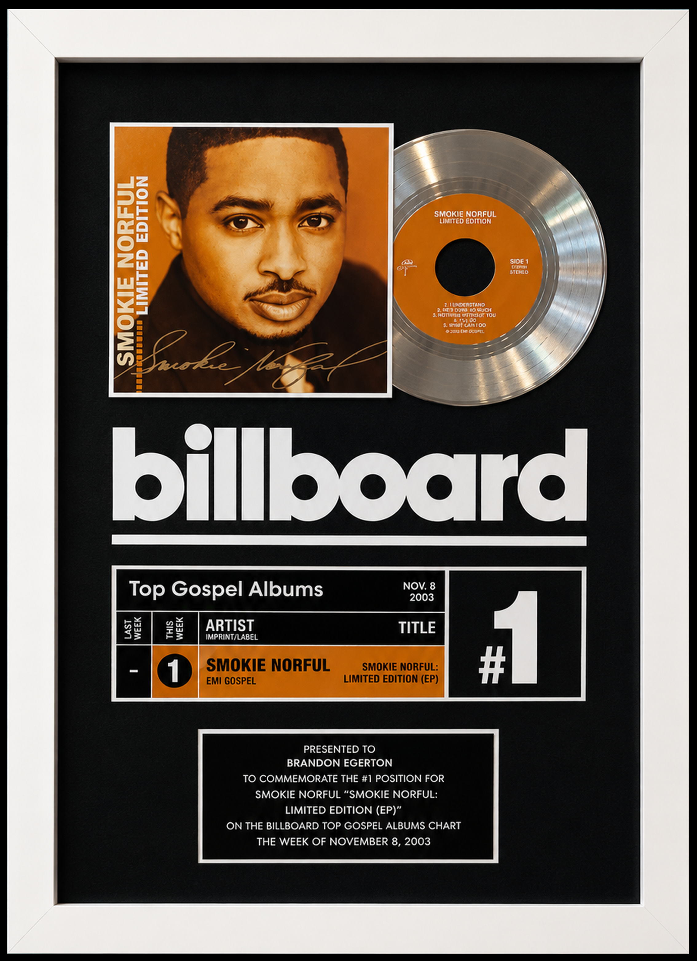 A framed Billboard chart with a platinum record and an album cover for Smokie Norful's 'Limited Edition' inside the frame. Presented to Brandon Egerton.
