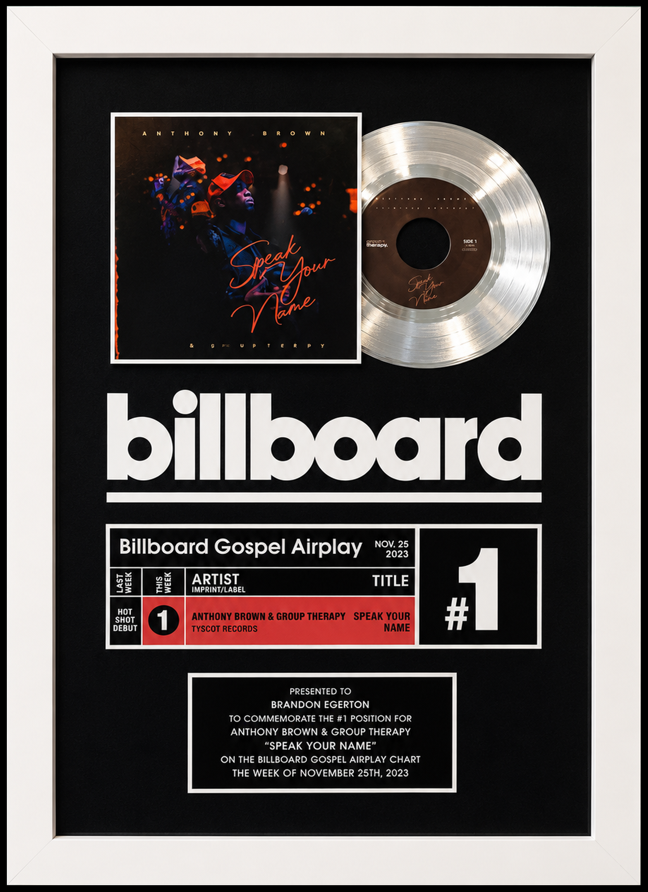 A framed Billboard chart plaque featuring a silver record and a stylized Billboard magazine cover with promotional details for Anthony Brown's debut gospel song 'Speak Your Name', awarded on November 25, 2023. Presented to Brandon Egerton.