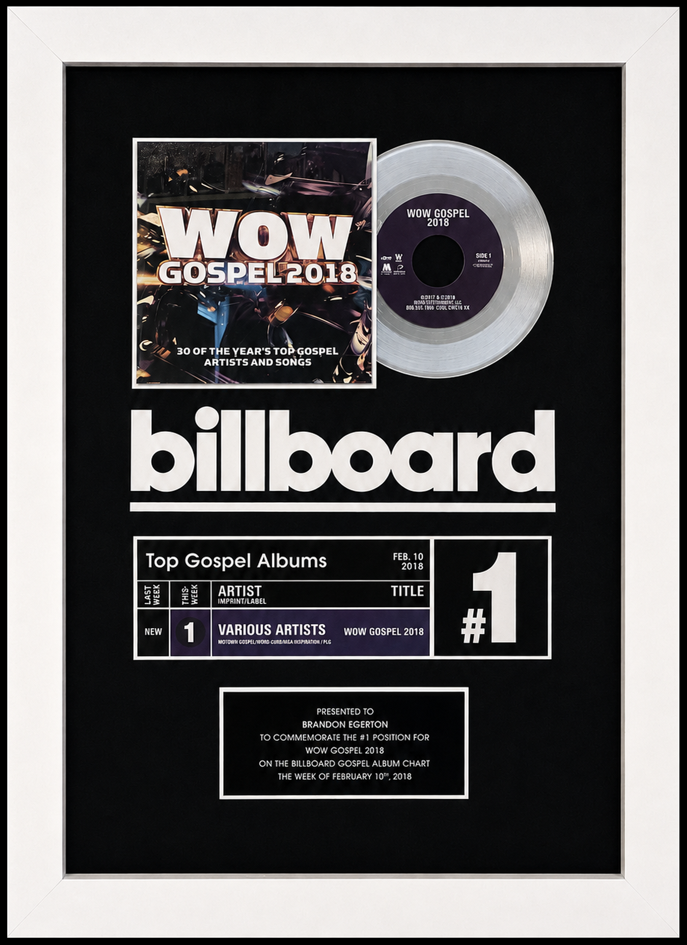 A framed silver record and a commemorative plaque celebrating being number one on the Billboard Gospel Albums chart for the week of February 10, 2018, for the album WOW Gospel 2018 by various artists. Presented to Brandon Egerton.