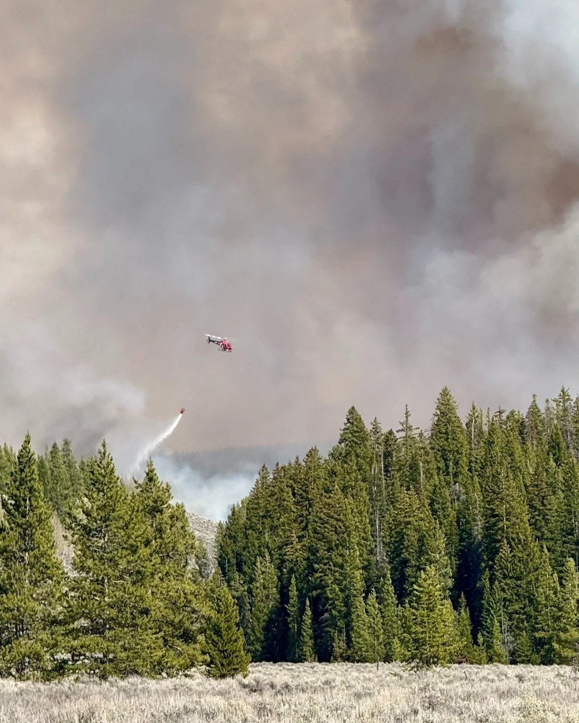 Teton County Search &amp; Rescue is one of several agencies working to fight the fire at Sagebrush Flats up Spread Creek. Fighting fire is something our heli team has been working toward and has even trained to prepare for such missions. 

Our team c
