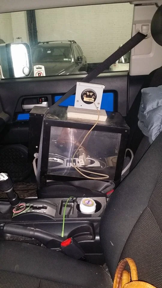 The chaos inside my car with the newer kiln strapped in to the front seat.