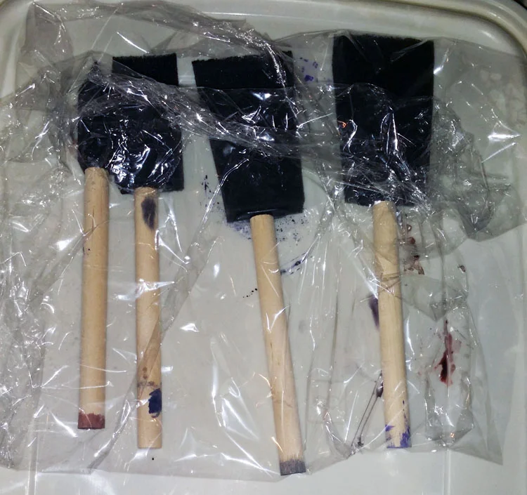 From left to right, Sennelier Tinfix dyes in Parme Rose 34, Indigo Gray 99, Cloud Grey 94, Indian Purple 43 (one of the most insanely saturated colors I have ever seen!). These cheapo foam brushes are great for dabbing on color.