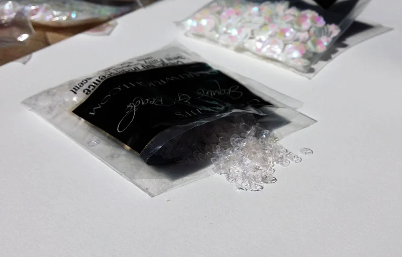 Transparent colorless mini-sequins.