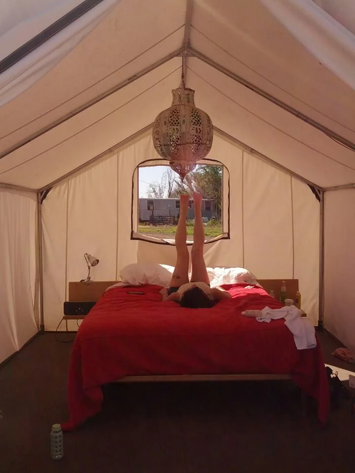 B luxuriating in our fancy-deluxe tent