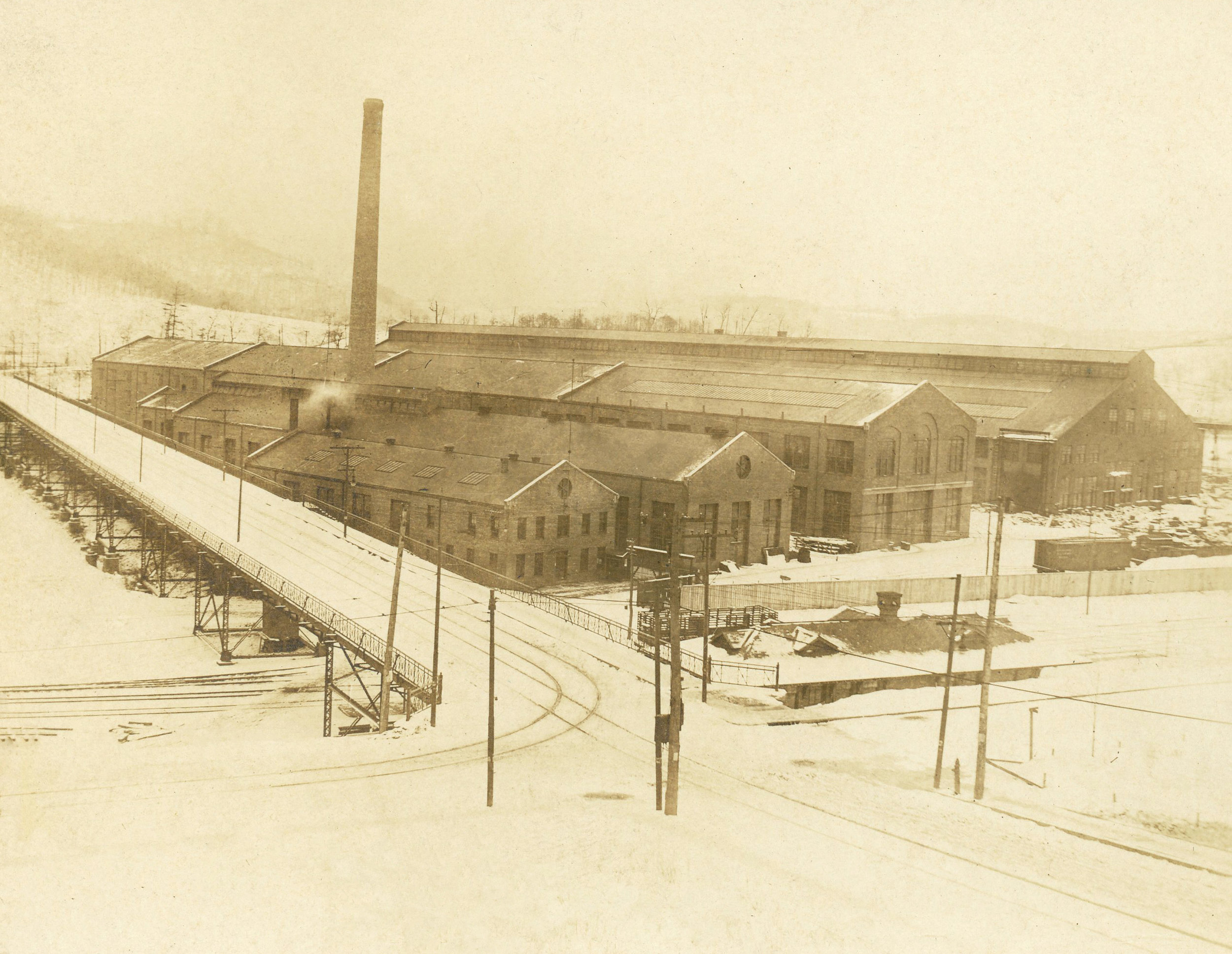 The Micarta Division at Trafford, PA is recognized as the largest plant of its kind in the world. The original plant, erected in 1929, had a total working area of ninety thousand square feet; today the floor space approximates two hundred and sixty thousand square feet. With present facilities, including presses up to 3750 tons capacity, more than one million pounds of material can be produced per month. Enough paper and cloth are need in one year to cover twenty-five thousand miles, o r a complete turn around the earth a t the equator. Micarta is a Westinghouse trade-name that covers all of the molded products manufactured by the Micarta Division. It is a plastic material using paper, cotton cloth, wood or fiberglass as filler materials. The fillers are impregnated with a fluid synthetic resin that is composed basically of phenol. When properly compounded with other chemicals this produces a fluid resin that can be changed to a solid by the application of heat. This change from a liquid to a solid is known as polymerization. The filler materials, after being impregnated, are partially dried, and later cut into sheets, rolled on metal mandrels or chopped into small sizes and molded in steam heated hydraulic presses. Carefully controlled temperatures as high as 350°F and pressures exceeding one ton per square inch are used. Micarta products are, pound for pound, as strong as structural steel; yet the? weigh only half as much as aluminum. The electrical properties are unsurpassed, and the effects of moisture, acid, and alkalies do not impair its usefulness. Ordinary metal working tools are used to machine Micarta into many useful industrial and decorative applications.