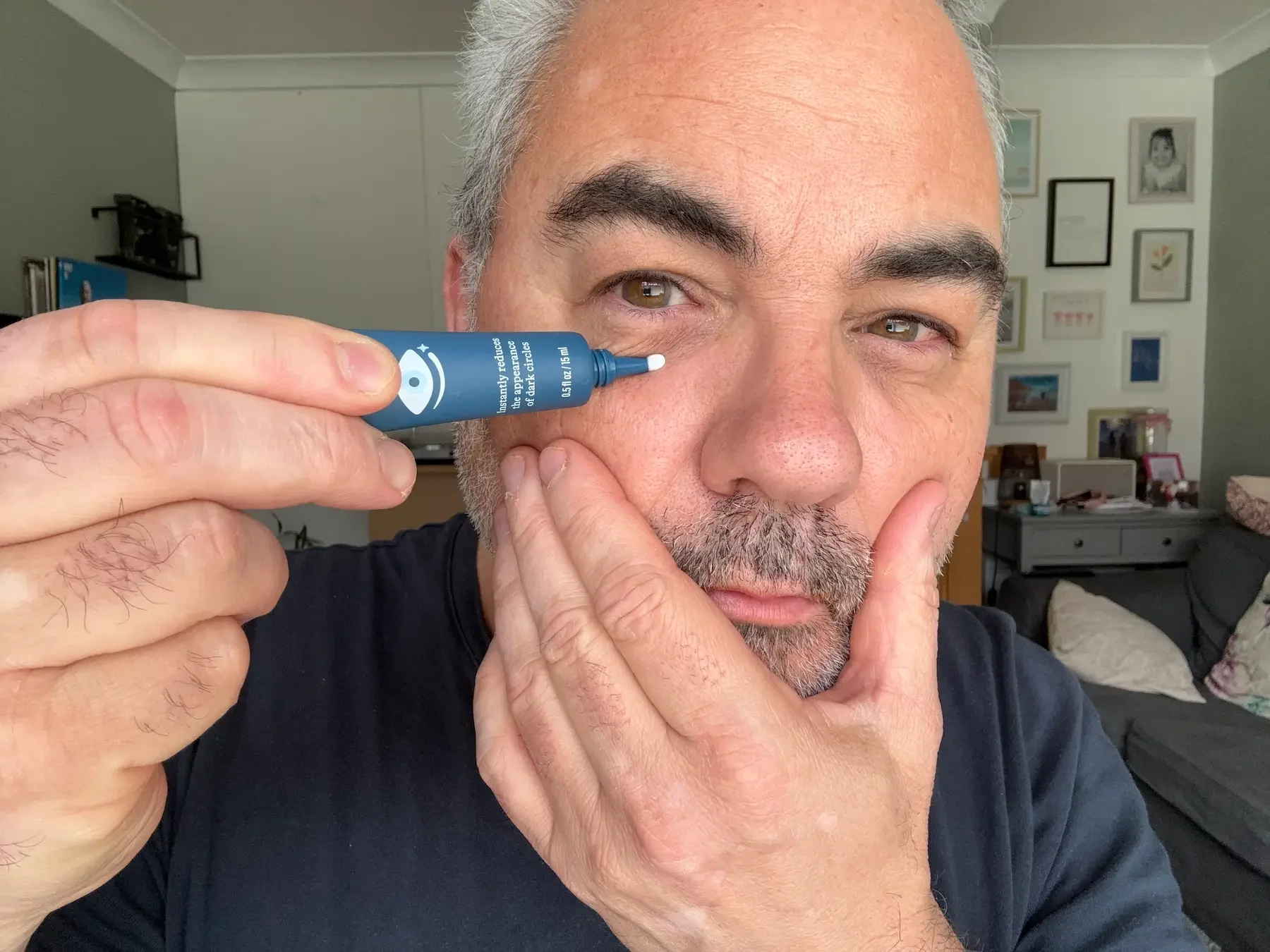 Jerome applying Harry's Brightening Eye Cream to show the light, fast-absorbing texture