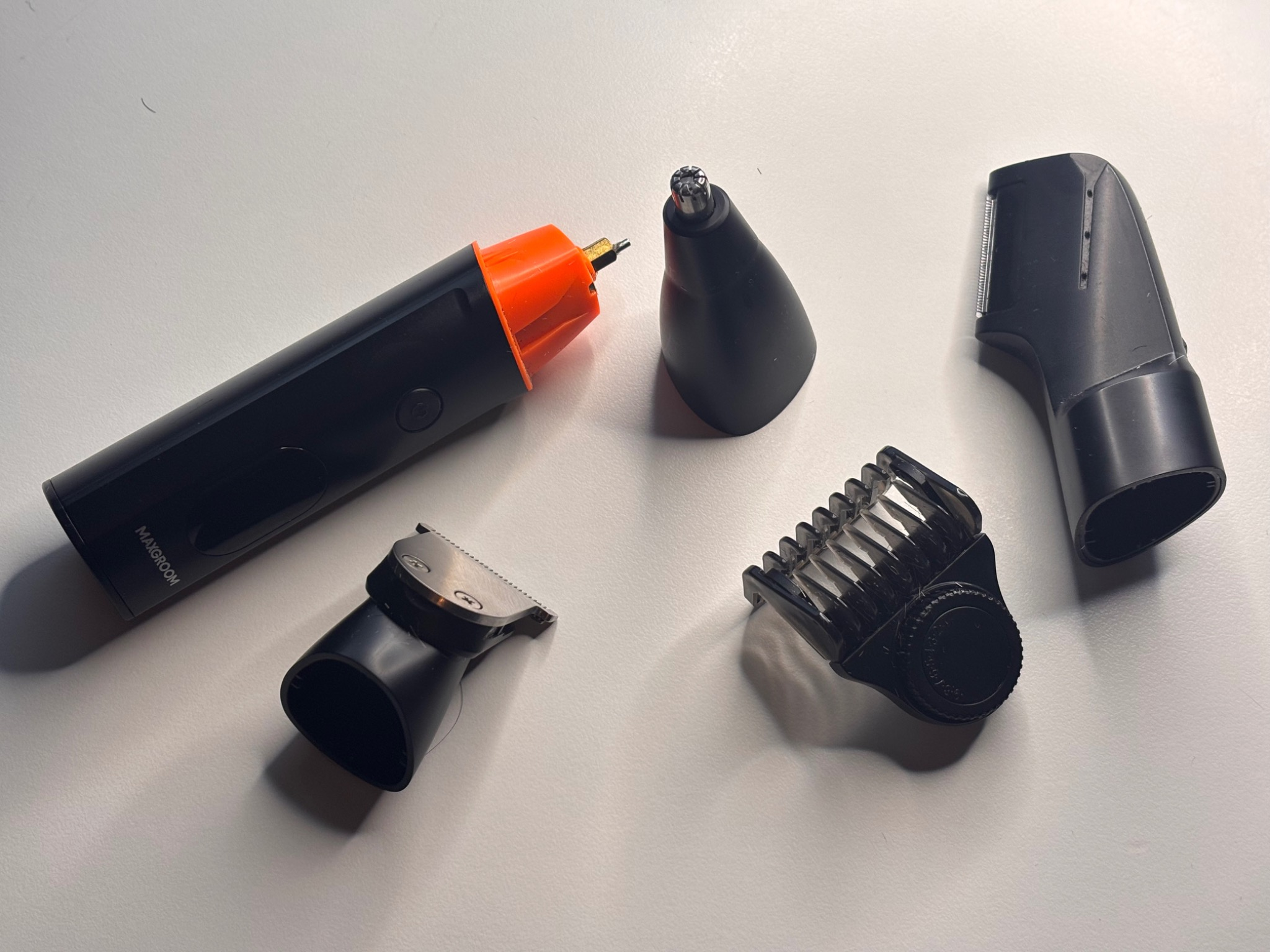 Maxgroom Manscape body hair trimmer with all attachments laid out