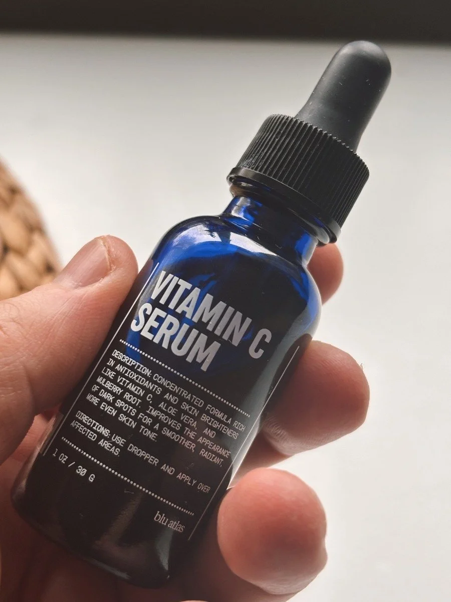 Blu Atlas Vitamin C Serum dropper bottle held in hand with label in focus