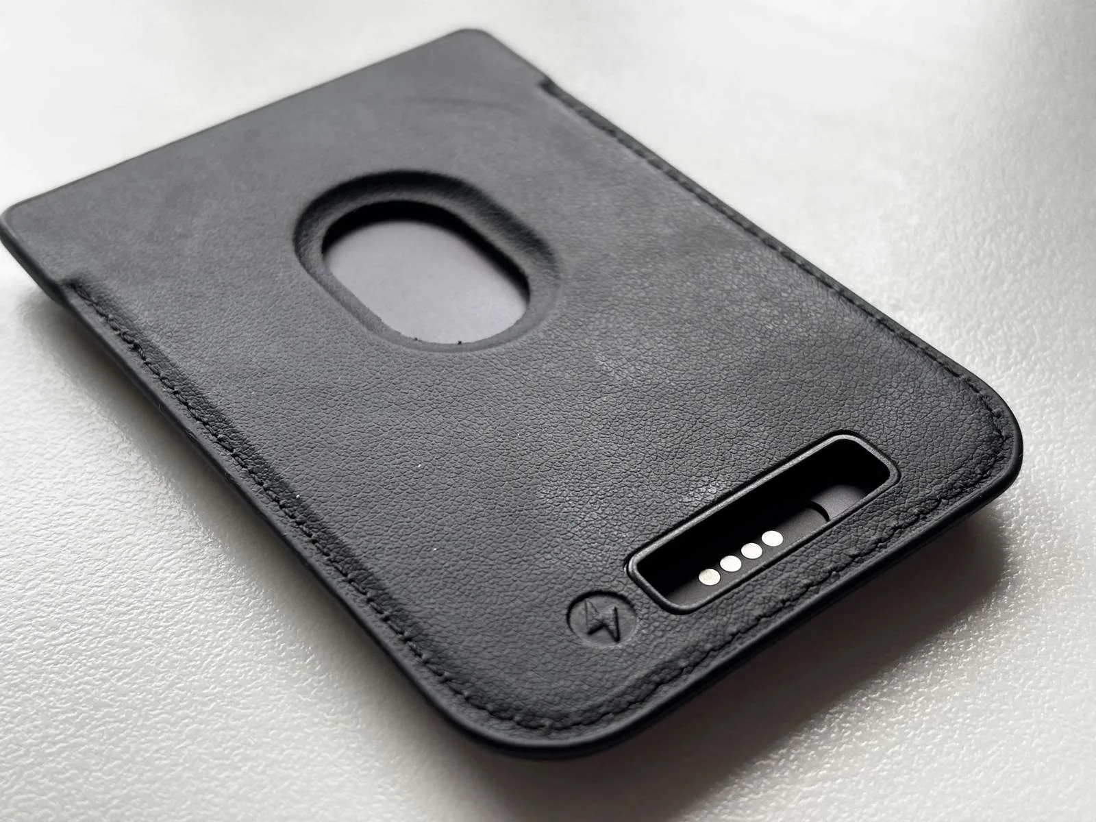 Close-up of the Plaud Note magnetic case showing the charging contact cutout and slim design