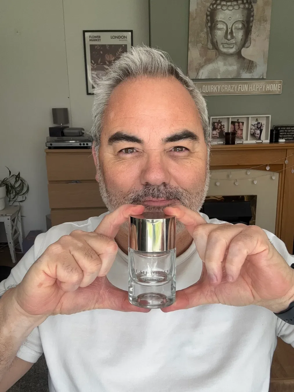 Jerome holds a bottle of Le Sel d'Issey by Issey Miyake for his fragrance review in his Bristol living room.