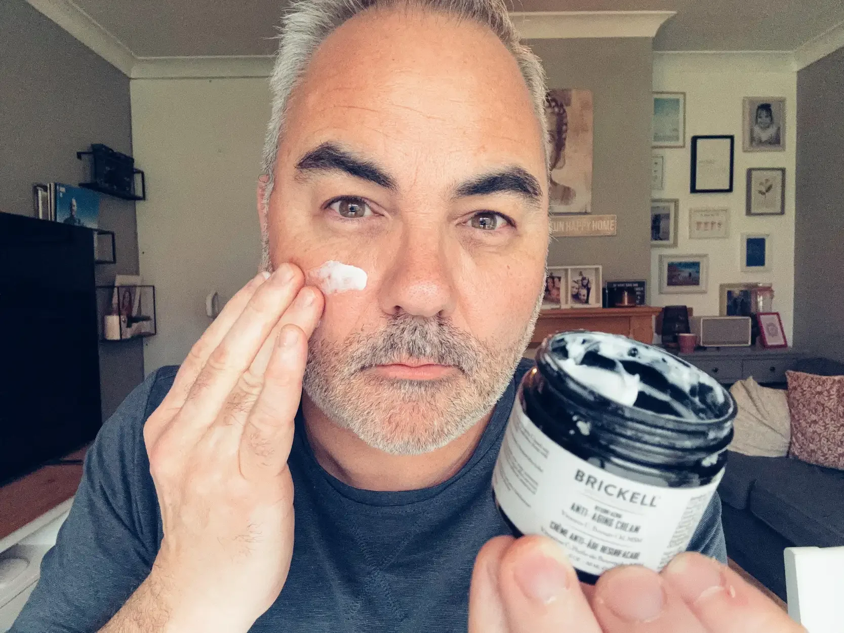 Jerome applying Brickell Resurfacing Anti-Aging Cream to his face — best anti-aging face cream for men over 40