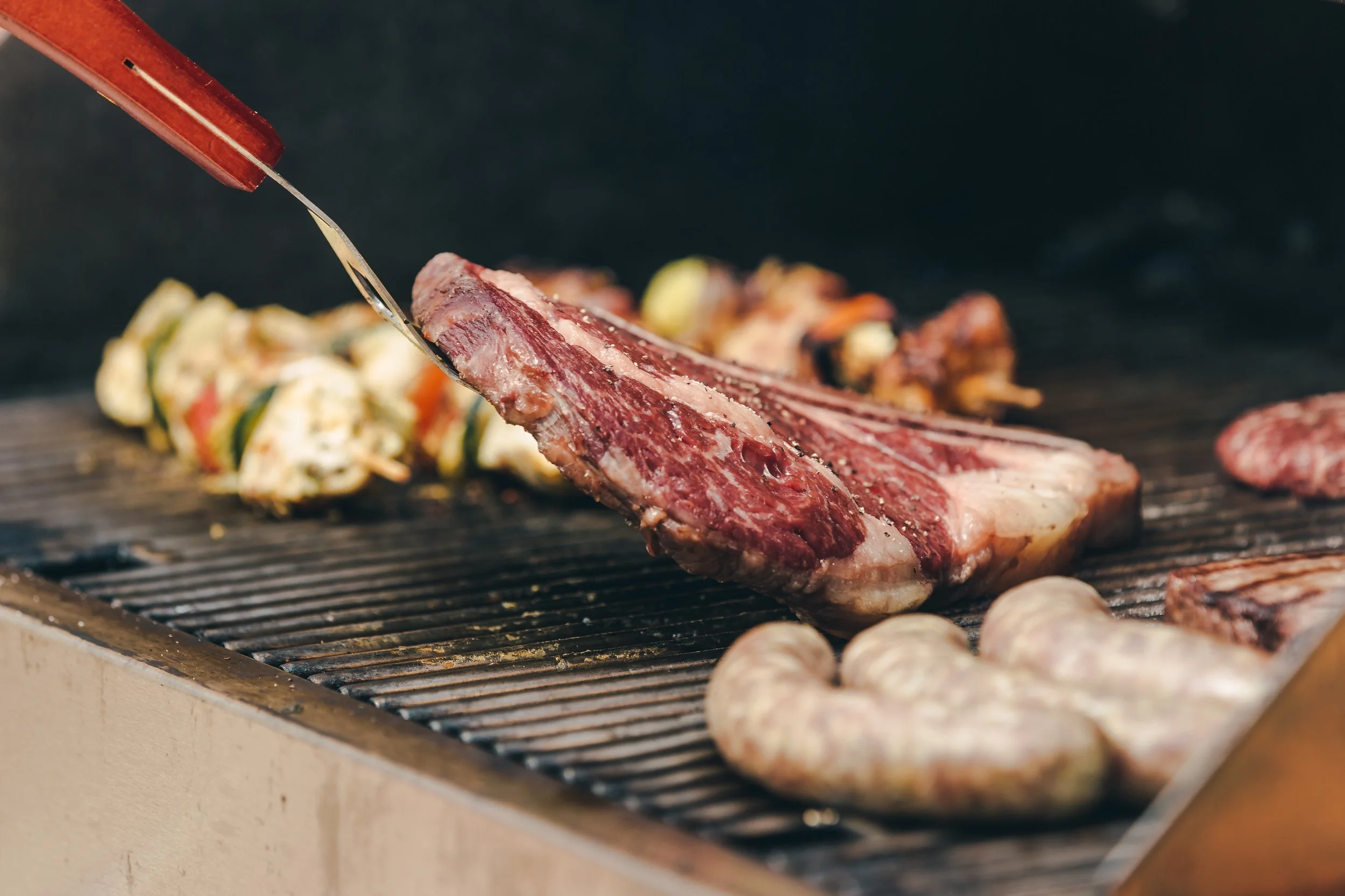 flipping-a-big-ribeye-steak-on-bbq_4460x4460.jpg