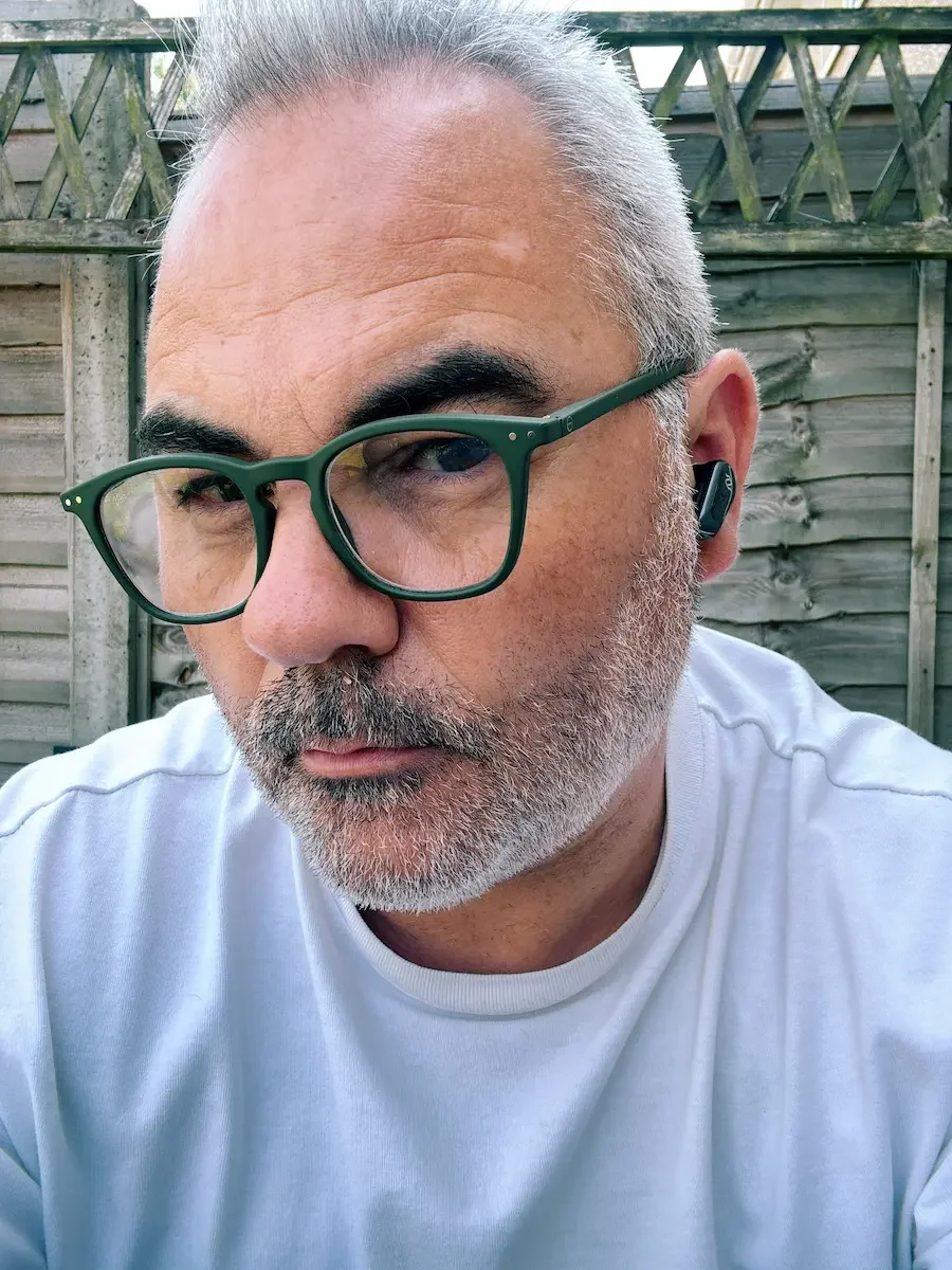 Close-up of Edifier STAX Spirit S10 earbuds being worn to test fit and comfort.
