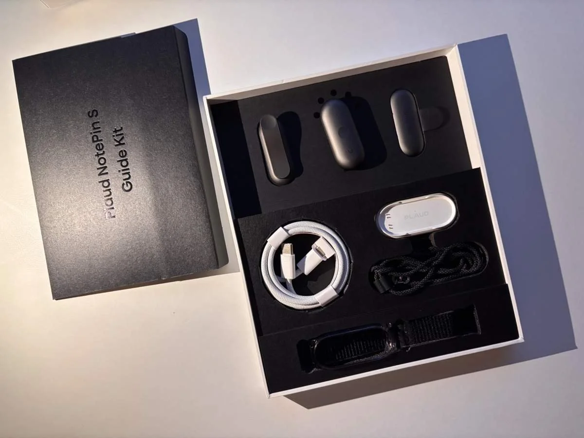 Plaud NotePin S retail box showing device, charging dock, wristband, lanyard and accessories