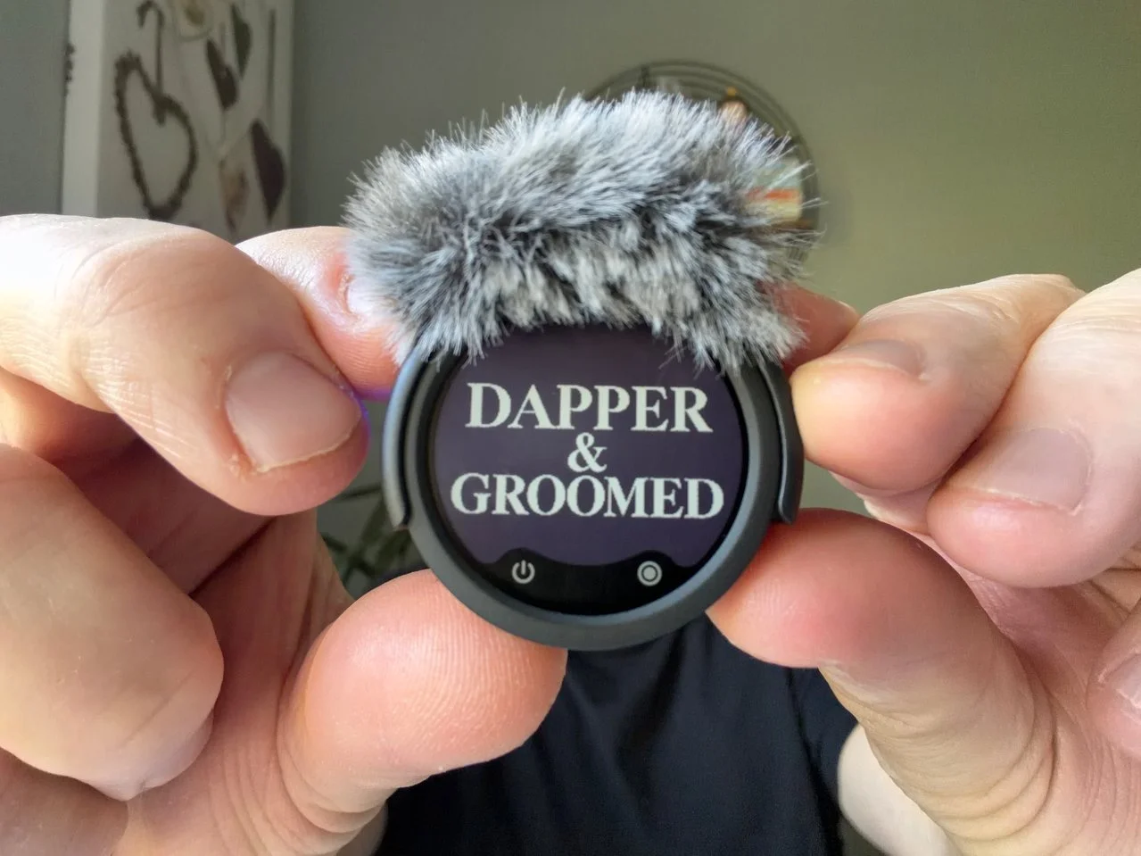 Insta360 Mic with windscreen and a custom black-and-white Dapper & Groomed E-Ink display.