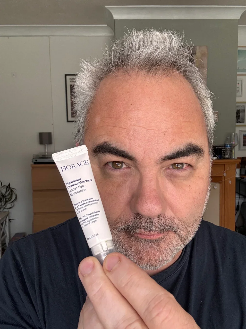 Jerome reviewing Horace Under-Eye Moisturizer with metal roller-ball applicator.