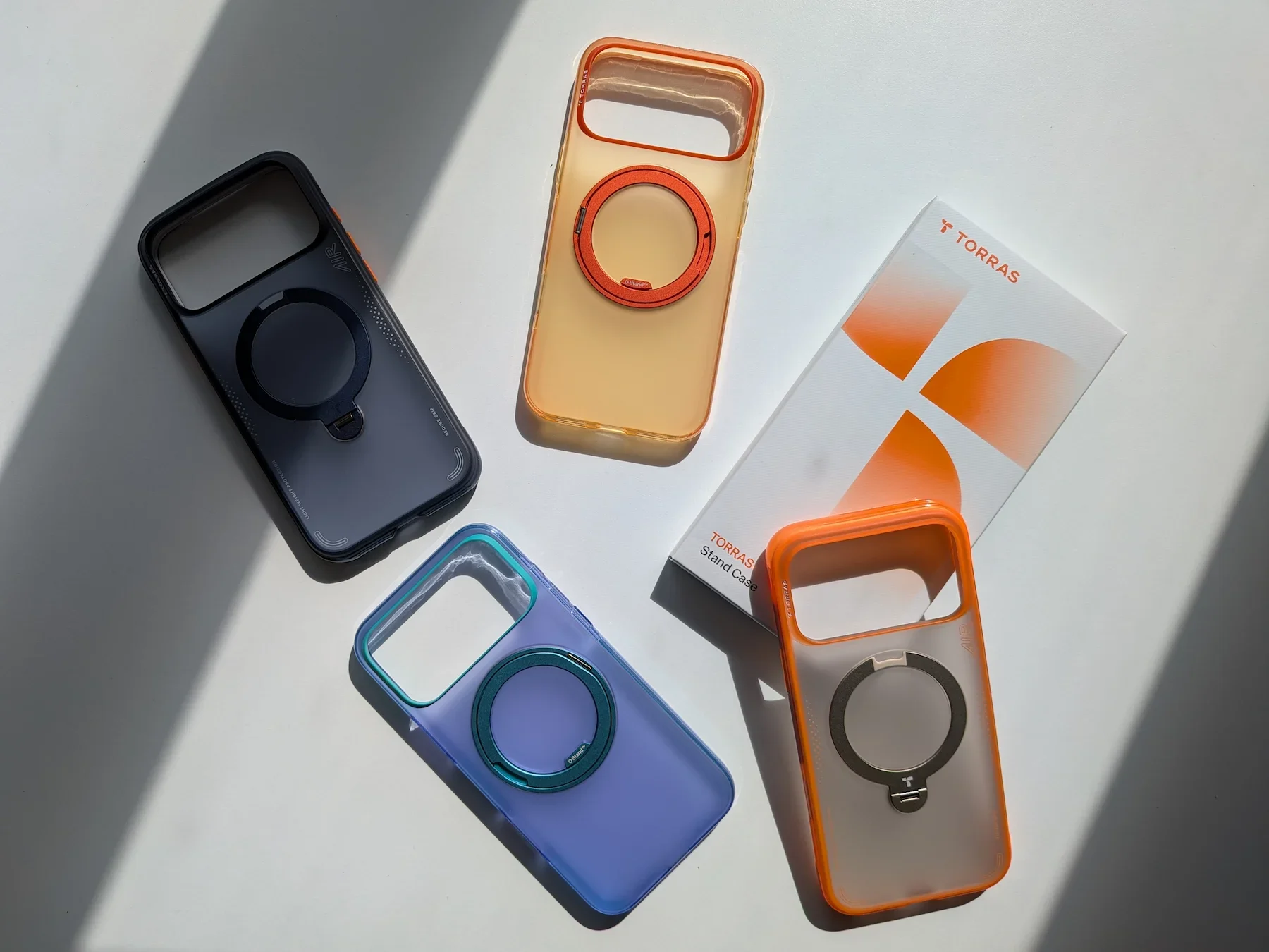 Four TORRAS Ostand Q3 cases for iPhone 17 Pro Max shown together in different colours alongside the retail packaging.