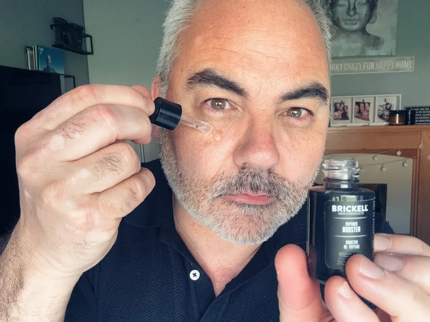 Close-up of Jerome applying peptide serum with a dropper to show texture and absorption.