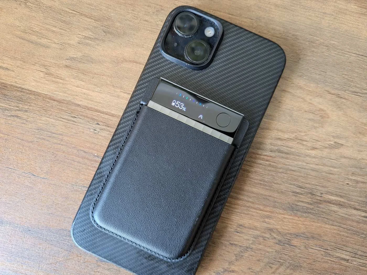 image of the Plaud Note Pro mounted on the back of an iPhone with its magnetic case, showing how the AI note taker fits into a mobile workflow.