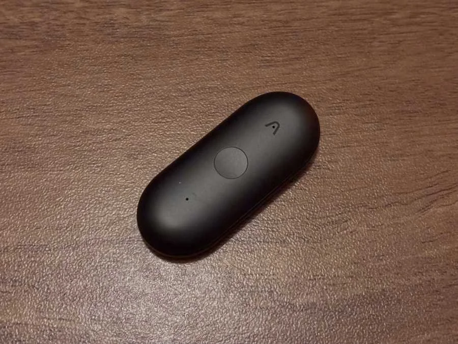 Close-up of the Plaud NotePin S wearable AI note recorder on wooden surface