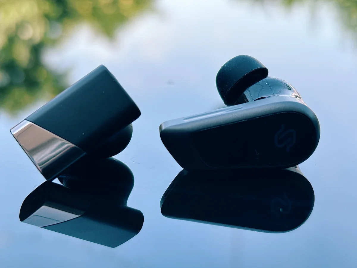 Side view comparing the Status Audio Pro X and Edifier STAX Spirit S10 earbud design.