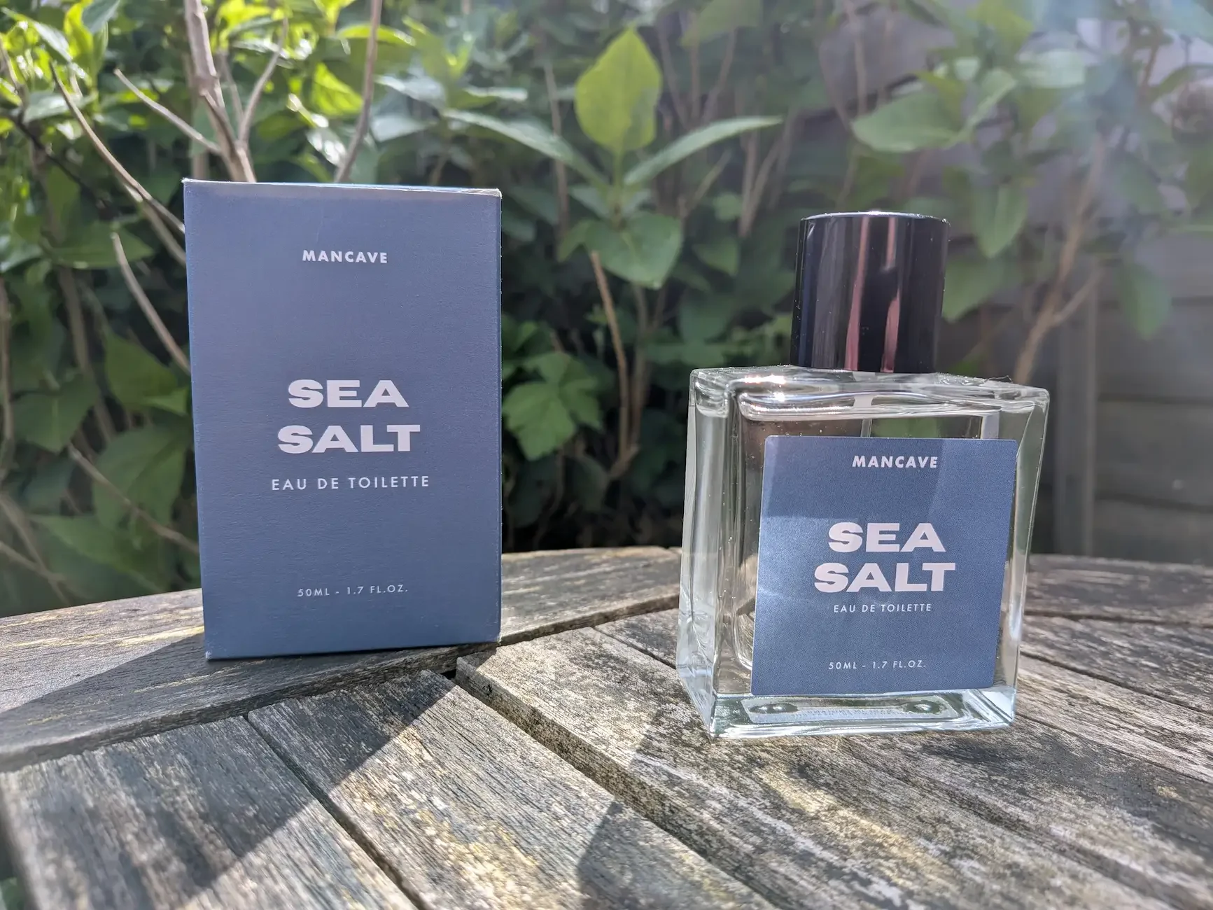 ManCave Sea Salt fragrance bottle and box displayed on a wooden outdoor table