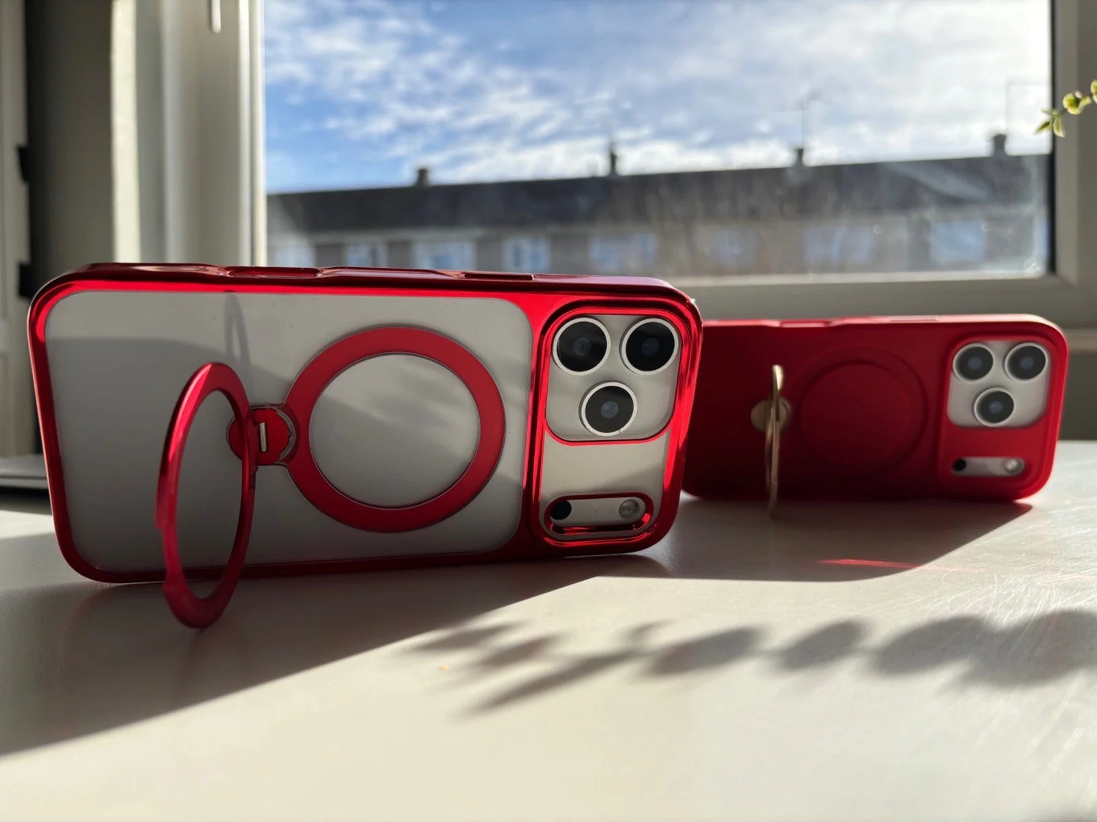 CASEKOO iPhone 17 Pro Max Spin Magnetic Stand Case in red transparent finish with rotating magnetic ring stand on desk