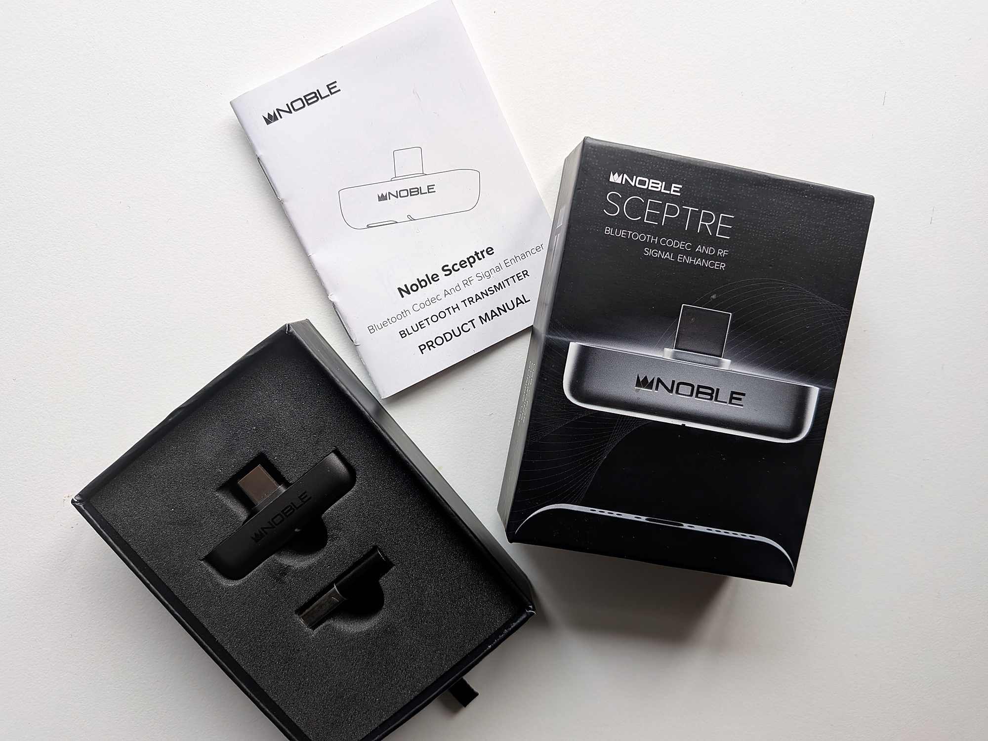 Noble Sceptre unboxing with product box, manual and USB-C dongle in foam insert.