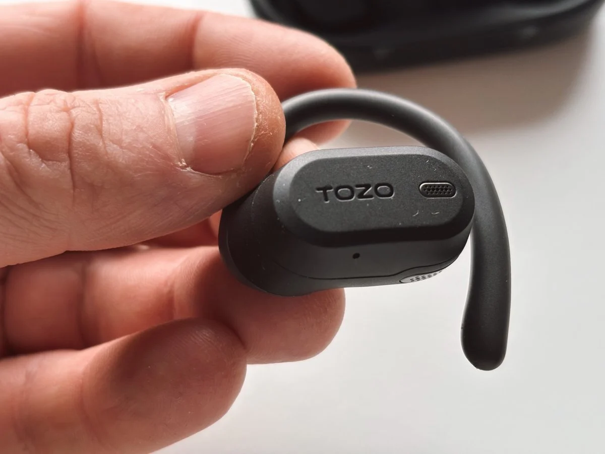 TOZO OpenWear open-ear earbud close-up in hand