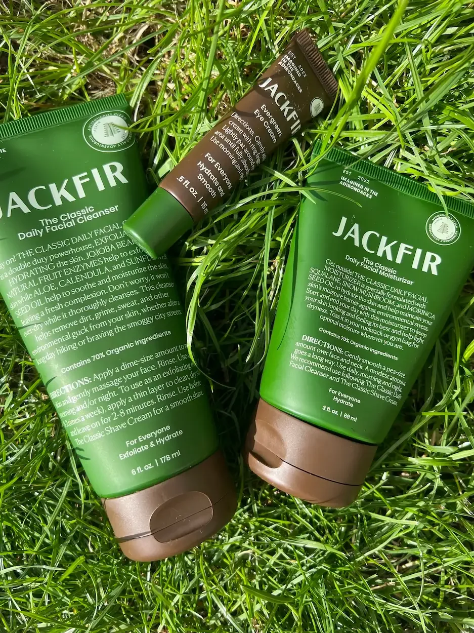 Jackfir Daily Facial Moisturiser, Eye Cream and Cleanser laid on grass — natural face cream for men tested by Jerome