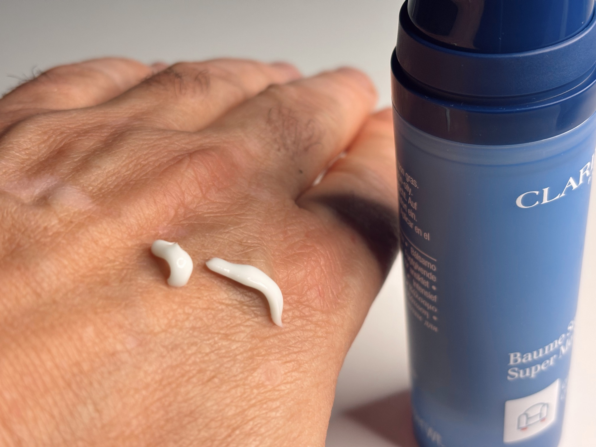 Clarins Men Super Moisture Balm texture shown on skin, lightweight gel moisturiser that absorbs quickly and hydrates mature skin