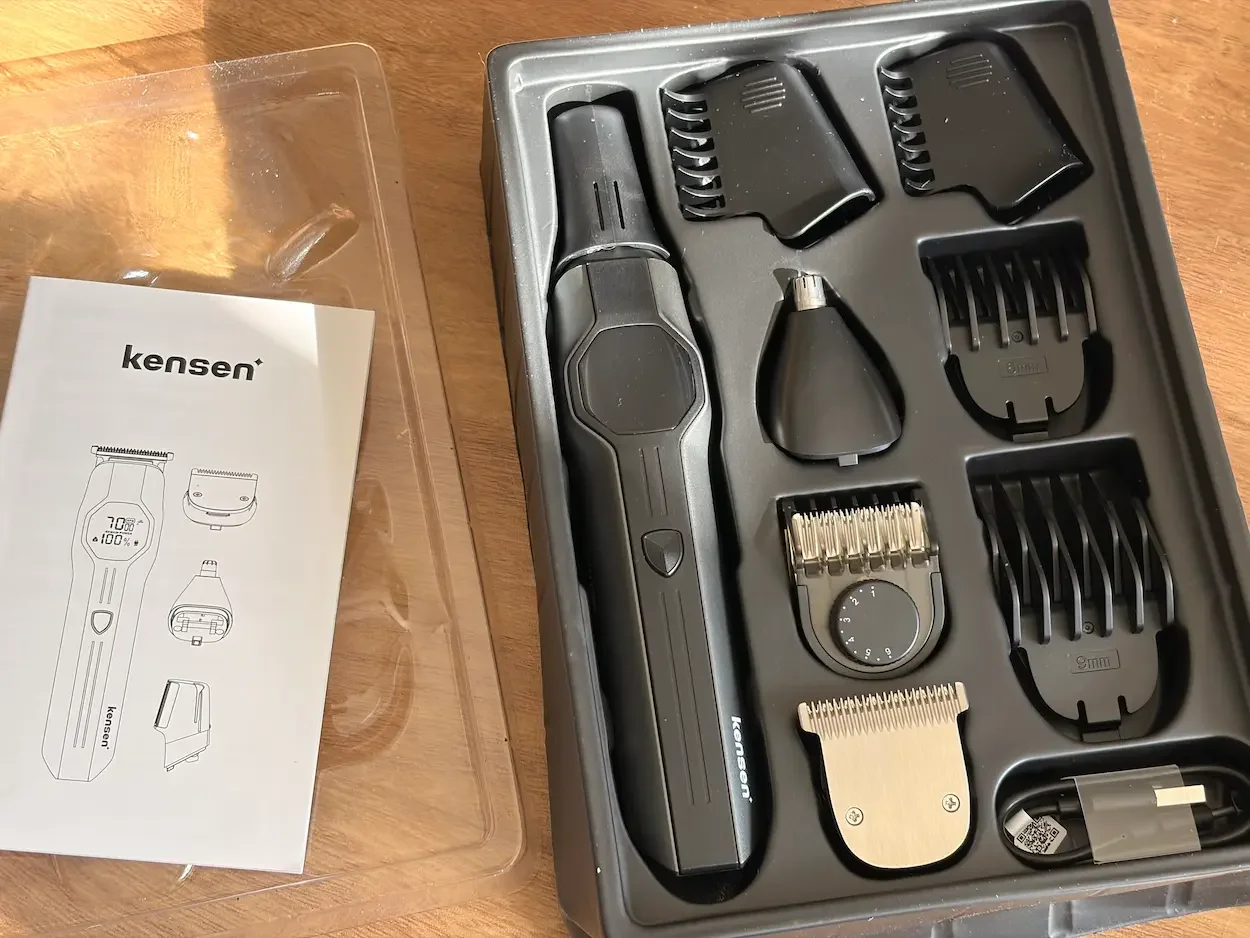 Kensen 4-in-1 Trimmer Kit with body, beard and nose attachments, trimming combs, charging cable and user guide.