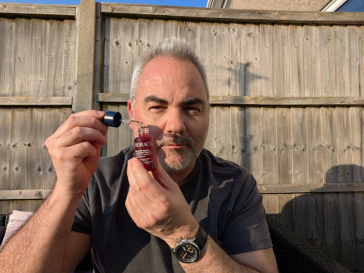 image of Jerome holding Horace Bio-Retinol + Argireline Peptide Serum outdoors for a men's skincare review, showing the product texture and packaging clearly.