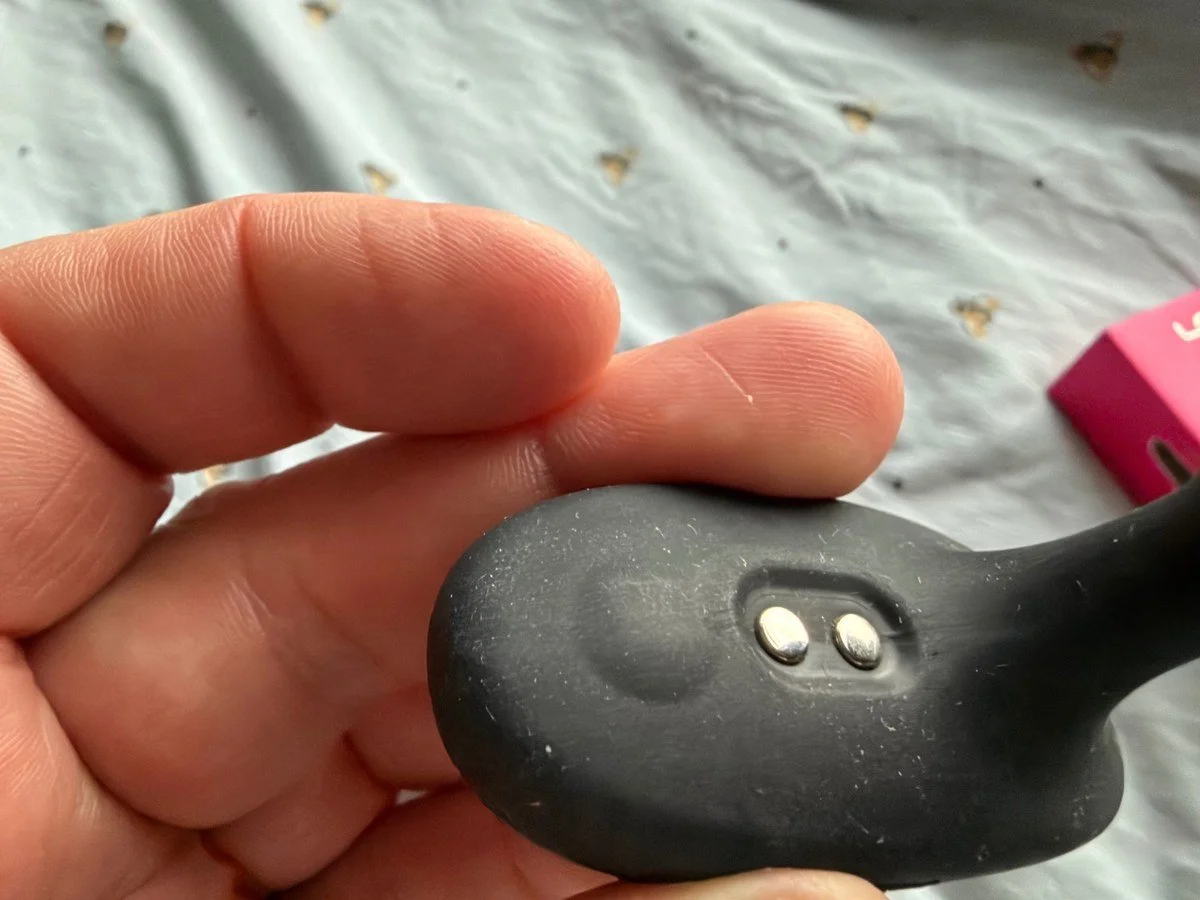Close-up of the Lovense Glint silicone base showing its two magnetic charging contacts.