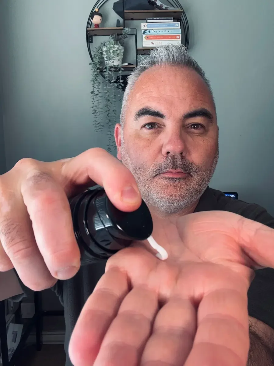 Manscaped Face Moisturizer being dispensed into the hand to show its texture