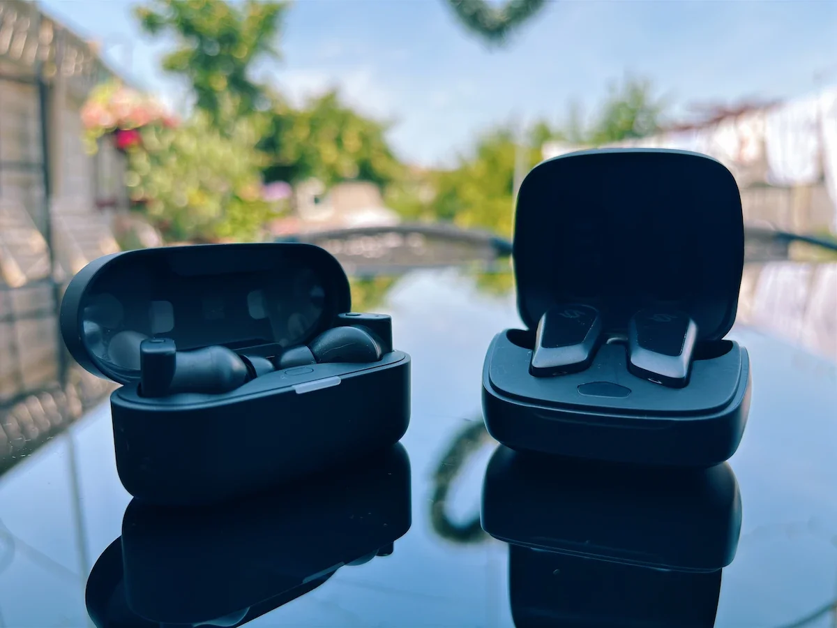 Edifier STAX Spirit S10 and Status Audio Pro X earbuds side by side in their charging cases.