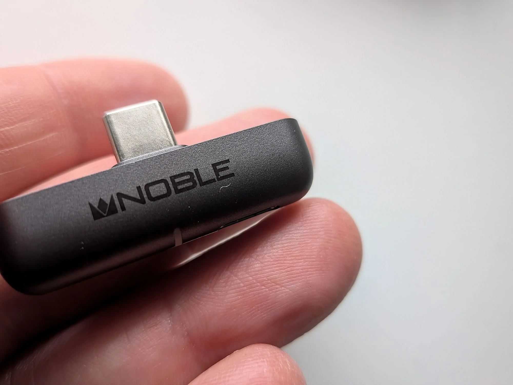 Noble Sceptre USB-C dongle close-up held between fingers