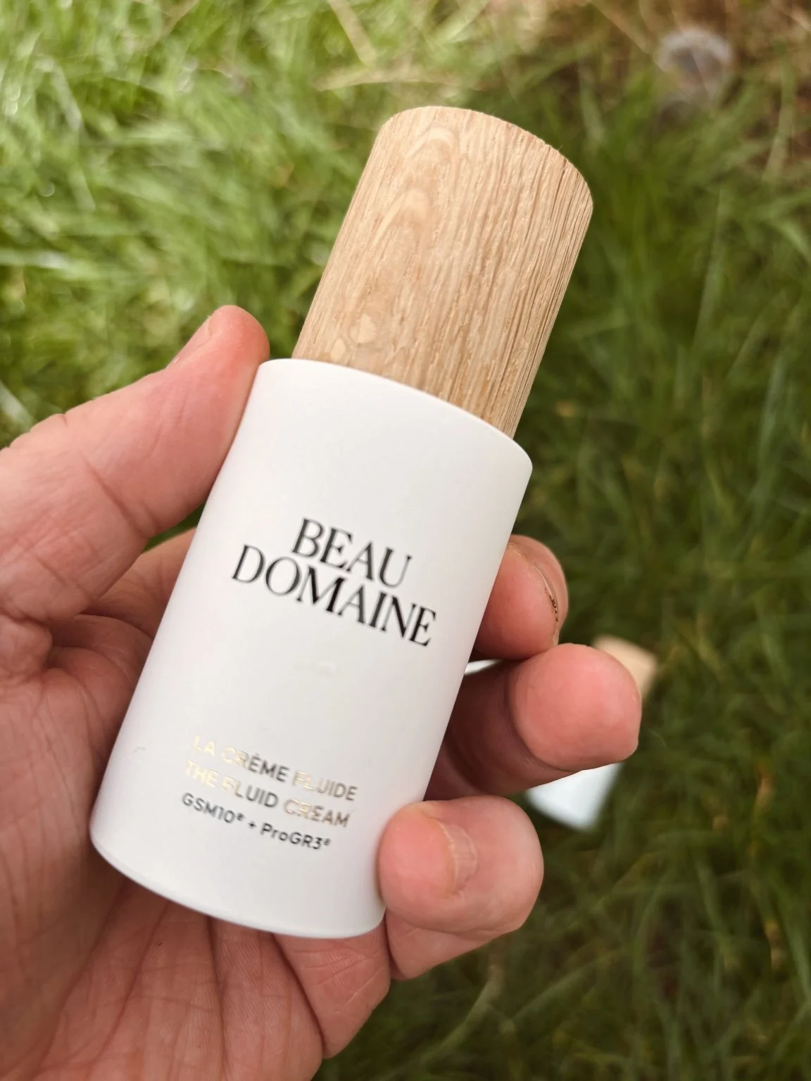 Beau Domaine The Fluid Cream bottle close-up outdoor