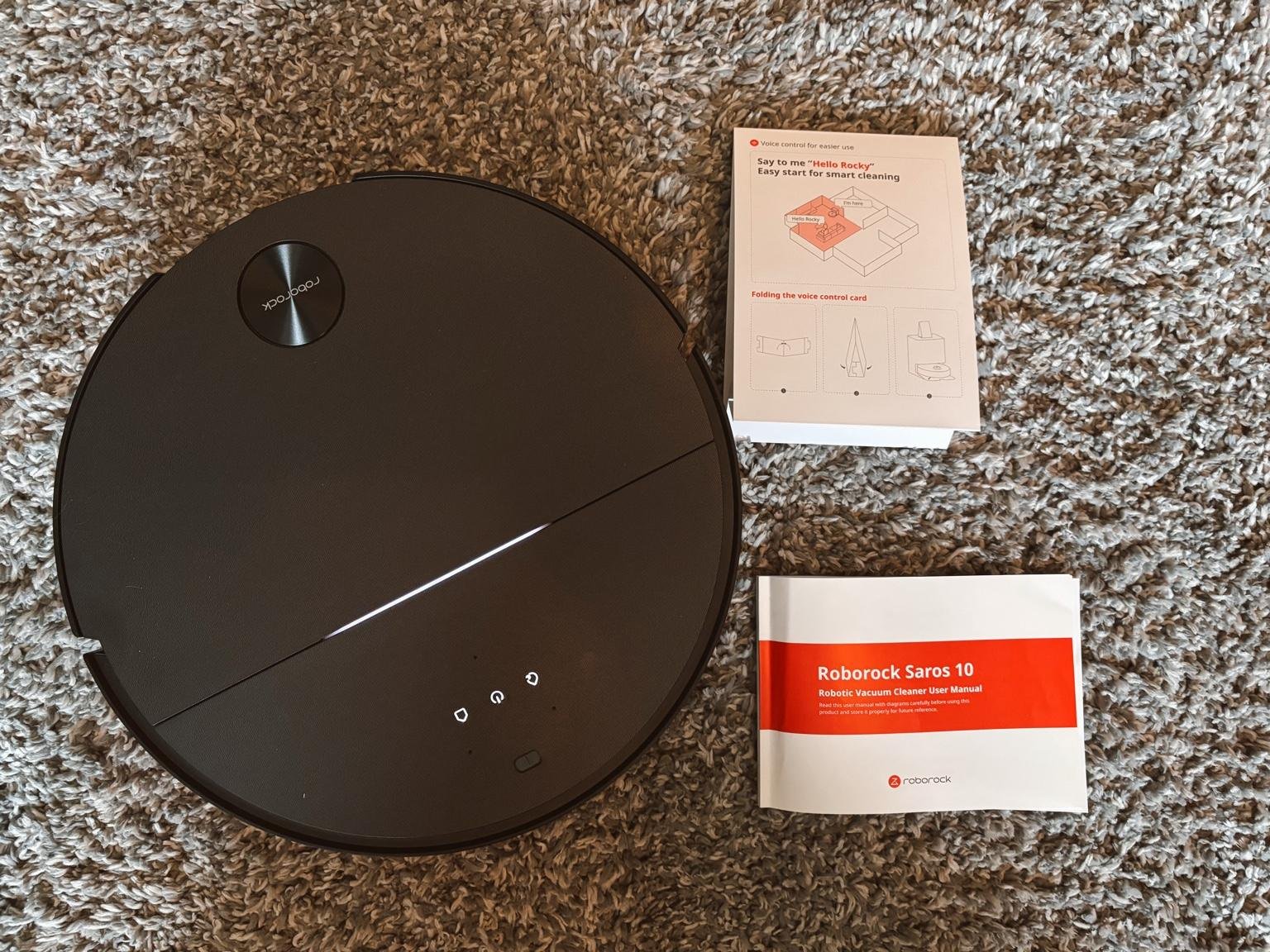 Roborock Saros 10 robot vacuum cleaner on carpet with user manual and voice command card – real home test by Dapper & Groomed