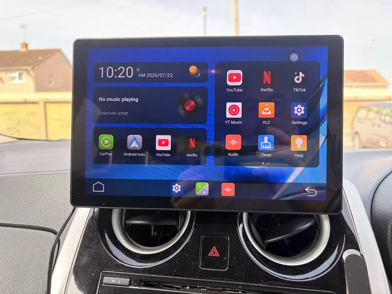 LAMTTO 11-inch car screen showing its home interface with CarPlay, Android Auto, YouTube, Netflix and TikTok.