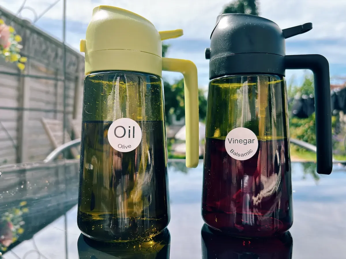Yarramate 2-in-1 oil and vinegar sprayer bottles filled with olive oil and balsamic vinegar.