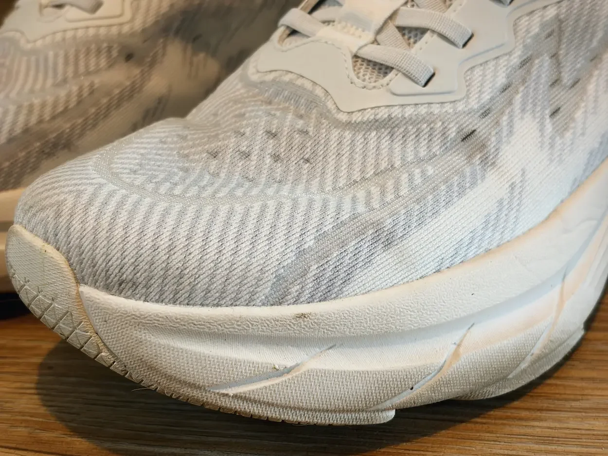Close-up of a white Allswifit ActiveSolid men’s trainer, showing the textured mesh upper and thick sculpted cushioning.