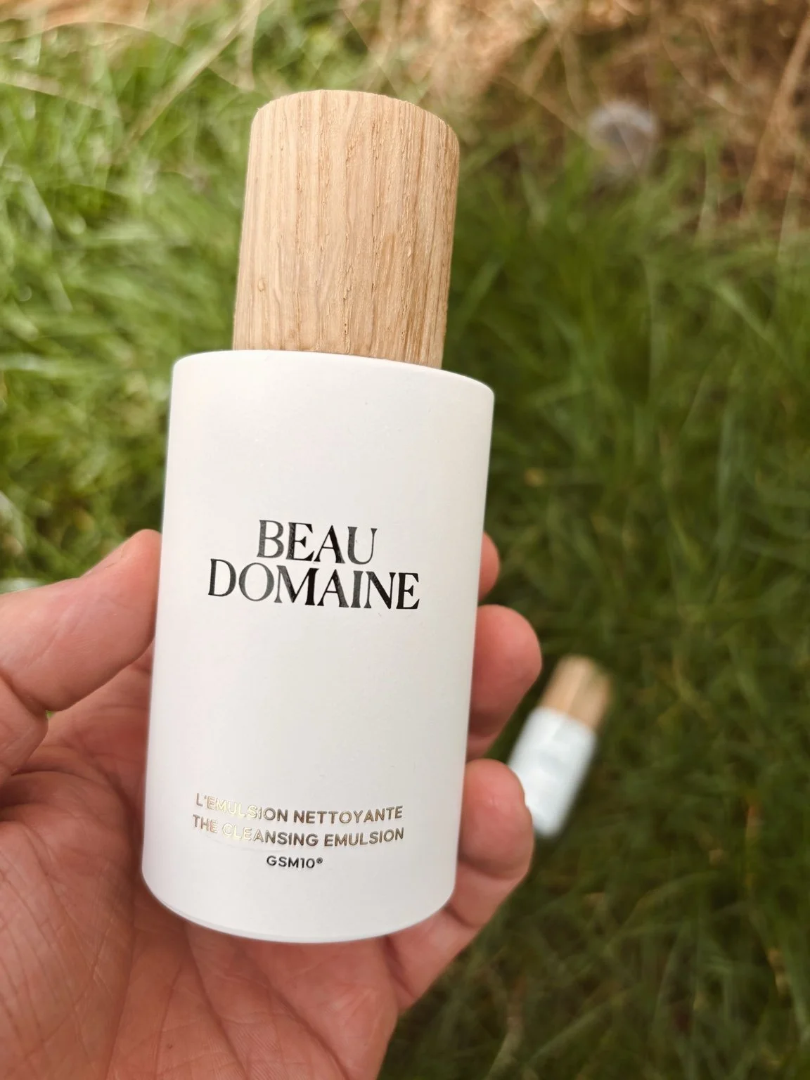 Beau Domaine Cleansing Emulsion bottle close-up outdoor