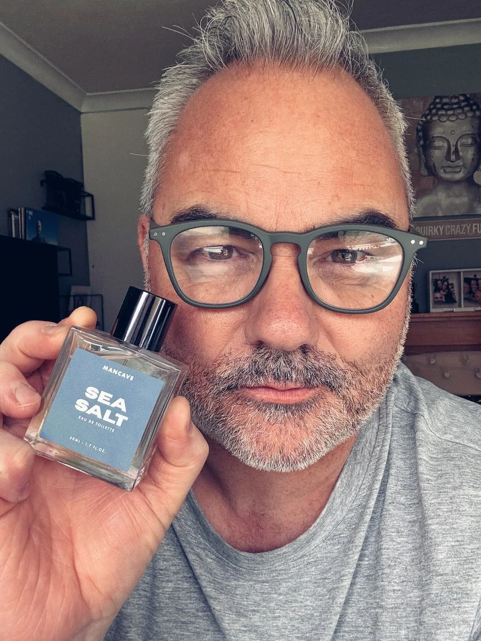 Jerome holding the ManCave Sea Salt fragrance bottle during his review