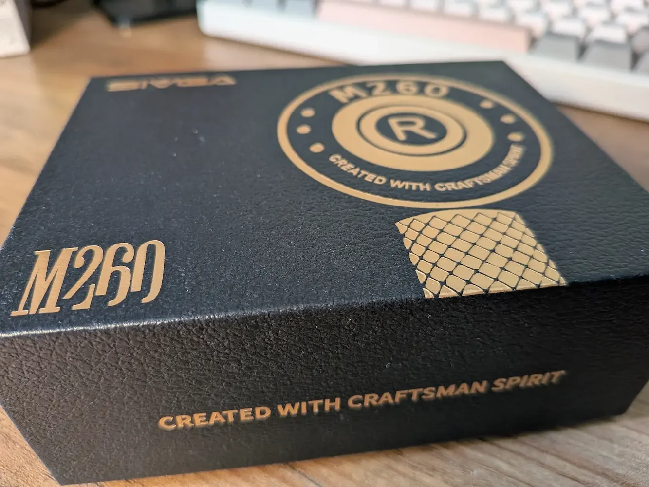 Close-up of the SIVGA M260 earphones packaging showing the black textured box and gold details