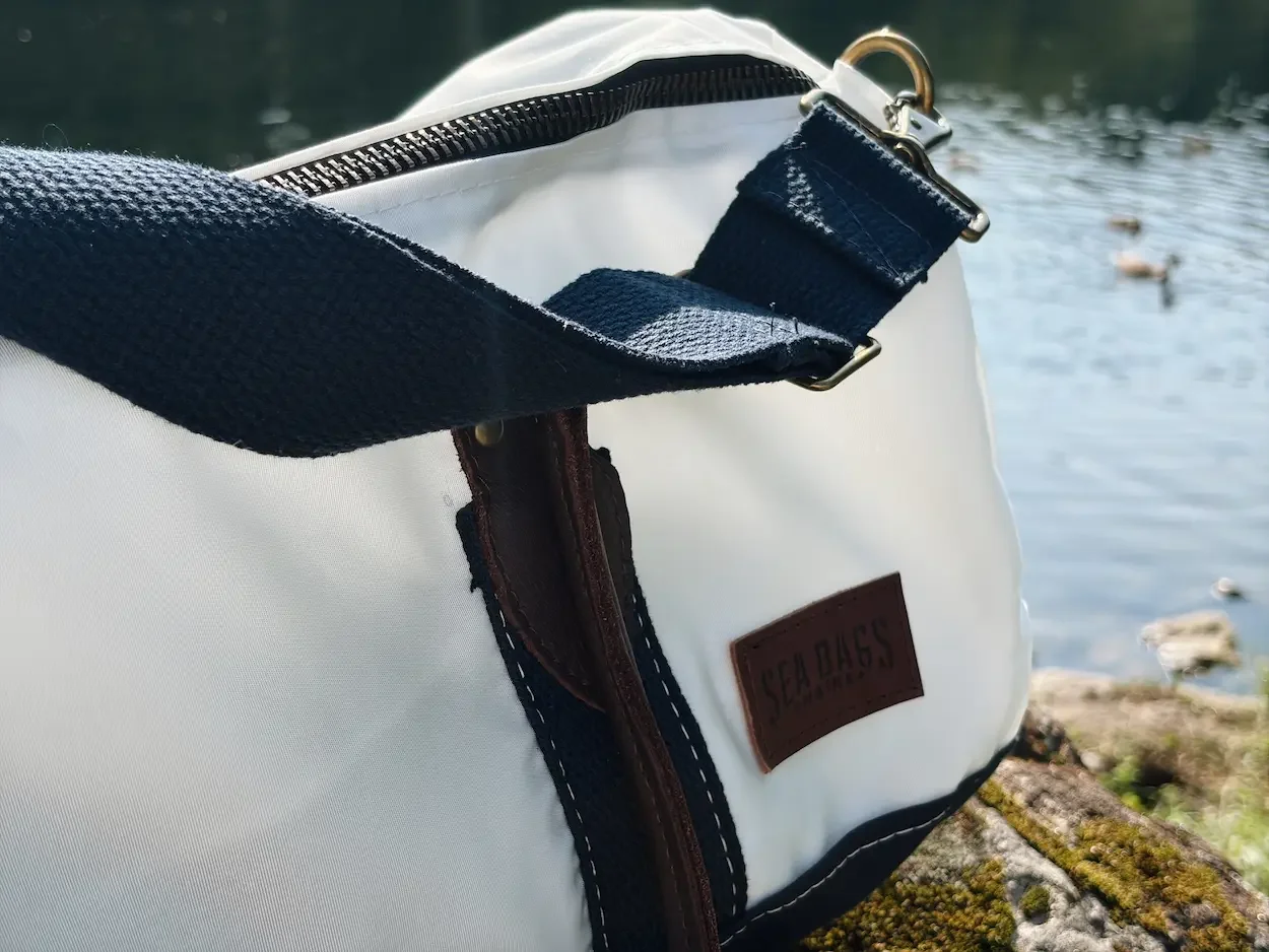 Wide navy shoulder strap and leather Sea Bags branding on the Chebeague Duffel