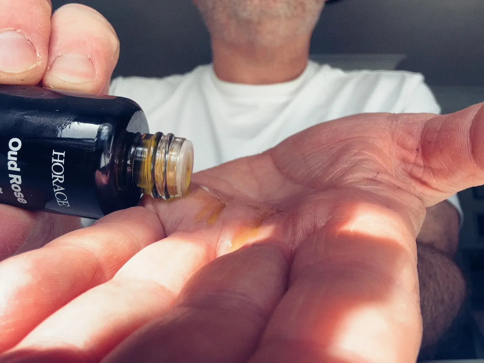 Horace Oud Rose beard oil being poured onto Jerome's hand