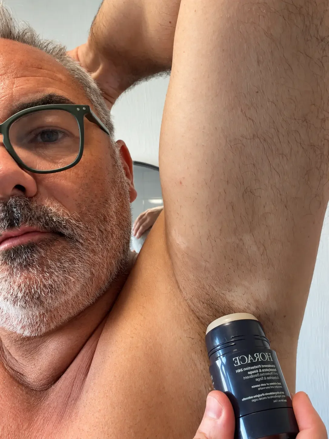 Jerome applying Horace 24H Protection Deodorant to a shaved underarm.