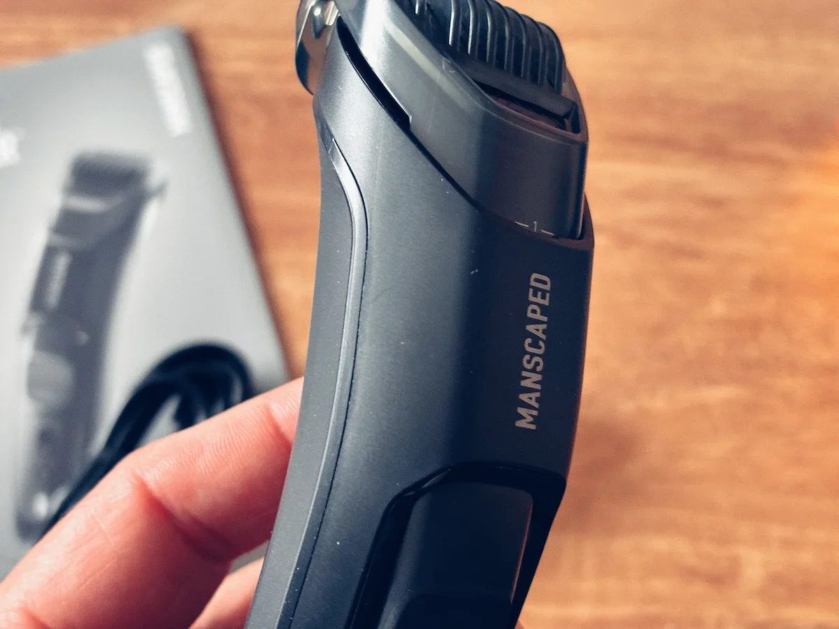 Side view of the Manscaped Beard Hedger Plus showing its compact ergonomic design and comb attachment.