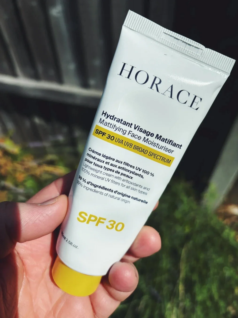 Jerome holding the Horace Mattifying Face Moisturiser outside.